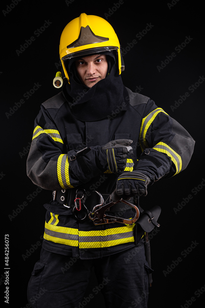 © blanke1973 - Firefighter in full firefighting gear on a black background © blanke1973 - Firefighter in full firefighting gear on a black background
