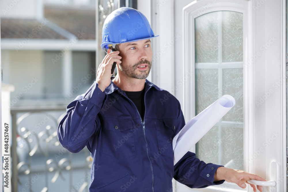 portrait of male architect talking on mobile phone outdoors