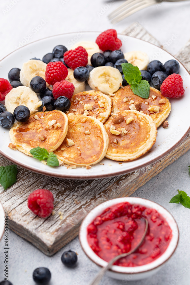Keto diet pancakes made or almond flour, served with berries. Keto diet pancakes made or almond flour, served with berries.