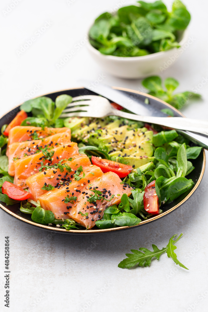 Salmon fish fillet with fresh salad, avocado top view. Salmon fish fillet with fresh salad, avocado top view.