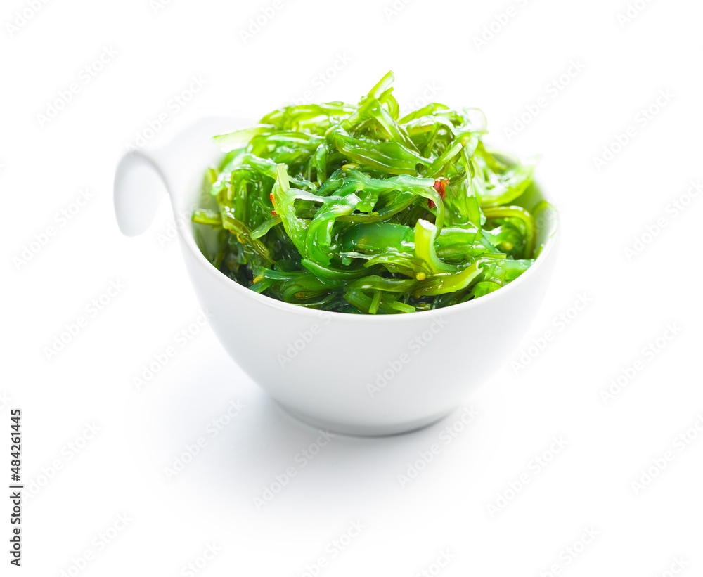Green wakame. Seaweed salad in bowl isolated on white background. Green wakame. Seaweed salad in bowl isolated on white background.
