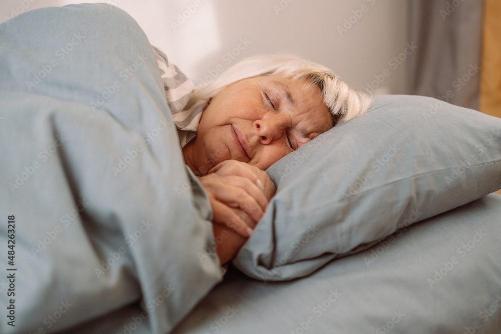 Beautiful 50s caucasian woman wearing pajamas sleeping in bed at home. Sweet Dreams Beautiful 50s caucasian woman wearing pajamas sleeping in bed at home. Sweet Dreams