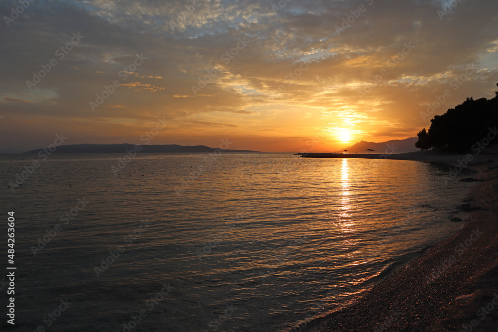 Picturesque sunset on the beach, sea coast of Croatia, Dalmatia, Makarska