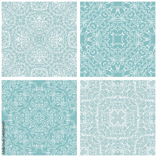 Set of ceramic tiles with lacy white ornament on light blue background. Winter motifs. Patchwork design.
