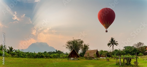 Hot Air Balloon and Sunset Over Hut
