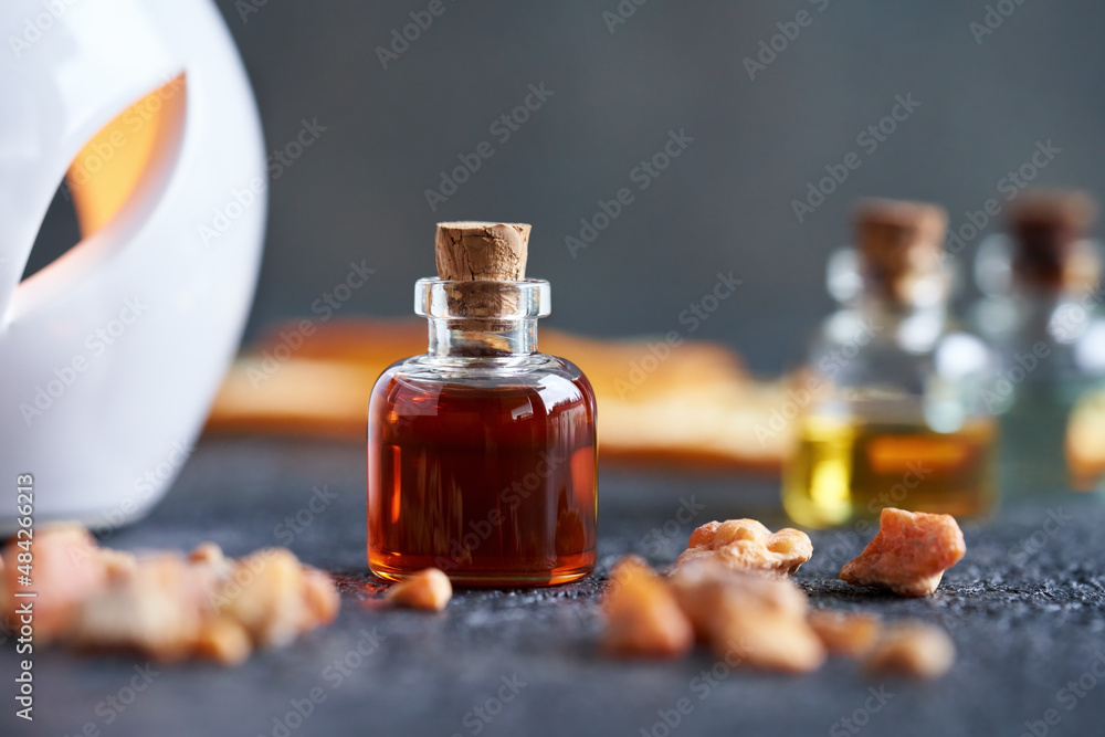 A bottle of styrax benzoin essential oil with benzoin resin. Aromatherapy or alternative medicine. A bottle of styrax benzoin essential oil with benzoin resin. Aromatherapy or alternative medicine.