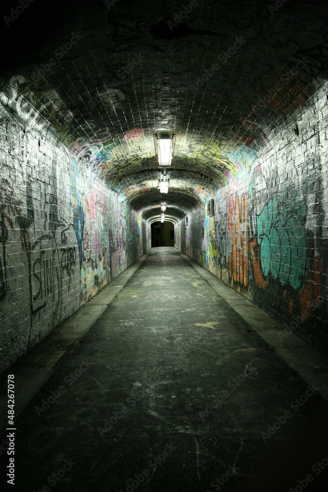 Grungy tunnel with graffitis