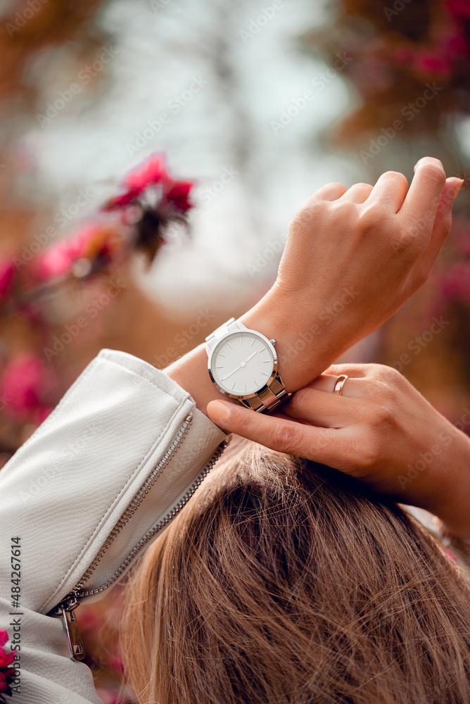 Elegant white watch on woman hand. Close up photo. Stock Photo