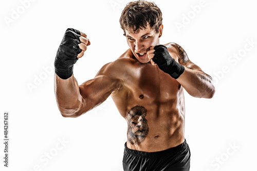 Portrait of aggressive boxer who training and practicing uppercut on white background. Sport concept