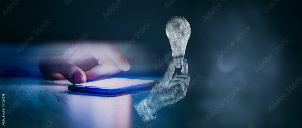 drawn hand holding a light bulb. man tapping on phone screen