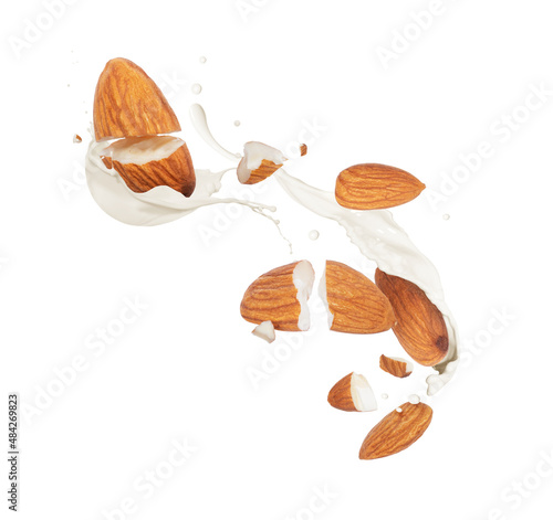 Tableau sur toile Crushed dried almonds with milk splashes in the air on a white background