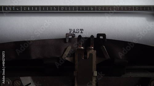 Typing word Past on a vintage typewriter. Close up. photo