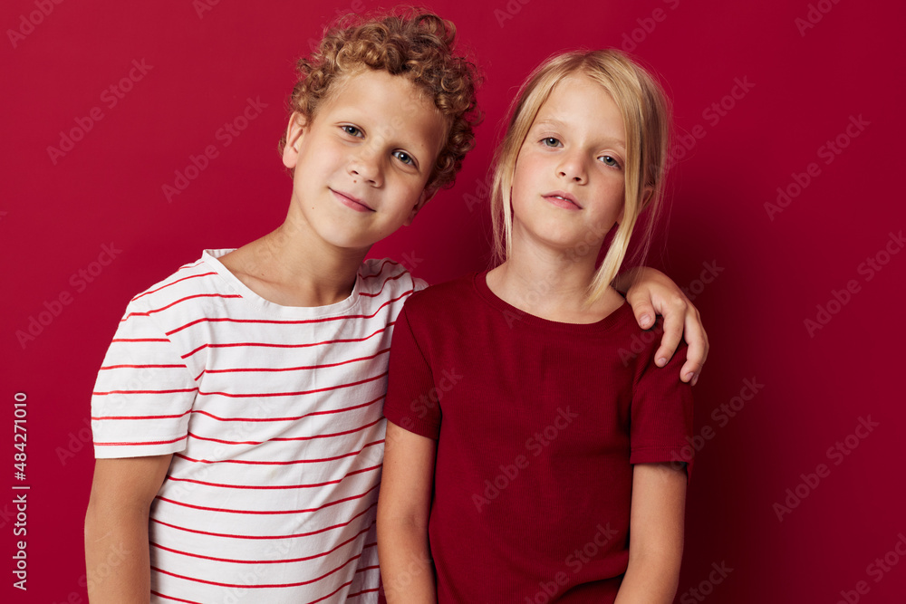 Portrait of cute children good mood standing next to posing on colored background Portrait of cute children good mood standing next to posing on colored background