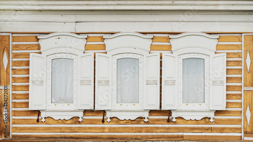 White wooden windows with shutters of old village house