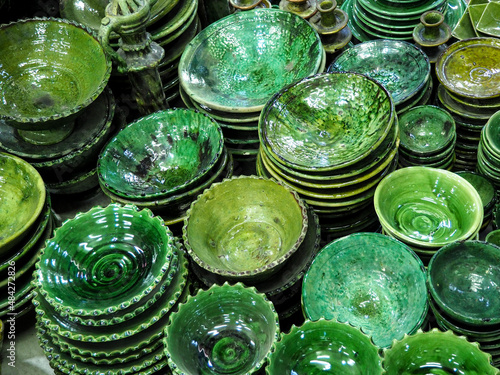 Pile of green plates or cups displayed at market in Morocco