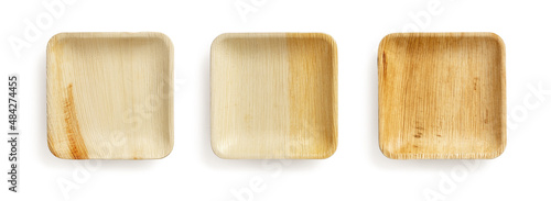 Set of three palm leaf plates isolated on a white background. Empty square textured plate of dry Areca palm leaves. Eco-friendly disposable natural tableware and dishes concept. Top view.