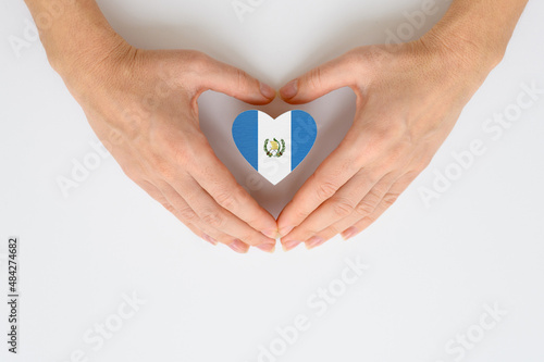 The national flag of Guatemala in female hands.