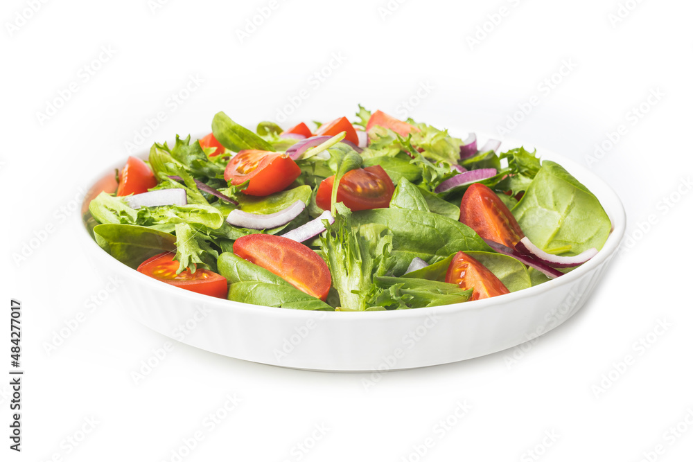Summre green salad in white bowl plate on grey table Summre green salad in white bowl plate on grey table