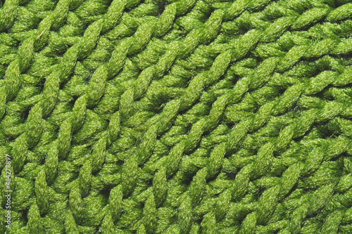 Knitted background close up. green woolen fabric