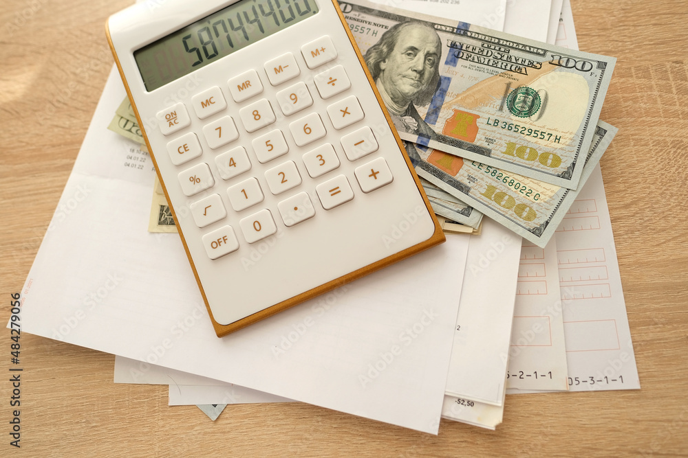 close-up of american dollars banknotes, financial documents, concept of filling out tax return, paying taxes, Corporate business income, expenses, maintaining household expenses, Gearing Up Startups close-up of american dollars banknotes, financial documents, concept of filling out tax return, paying taxes, Corporate business income, expenses, maintaining household expenses, Gearing Up Startups