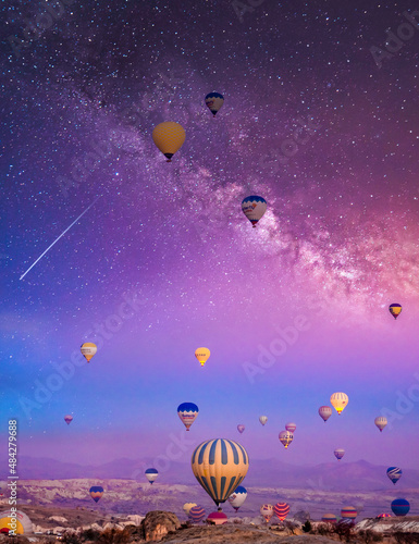 Bright multi-colored hot air balloons flying in starry sky Cappadocia