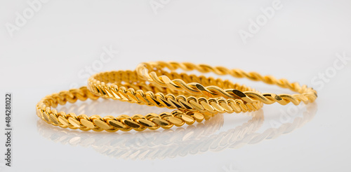 Gold jewelry. Gold bangle on background