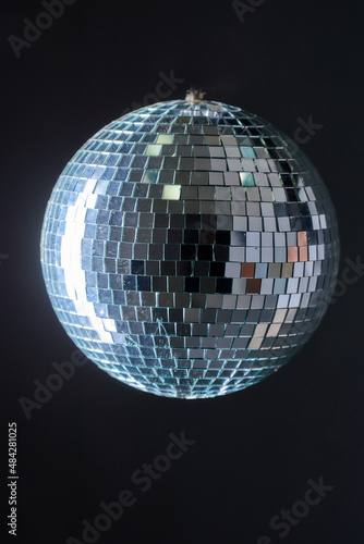 A hanging disco ball, retro partying, details of a mirrored surface