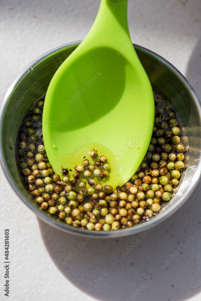 Pinch bowl with cilantro berries also called green coriander seeds