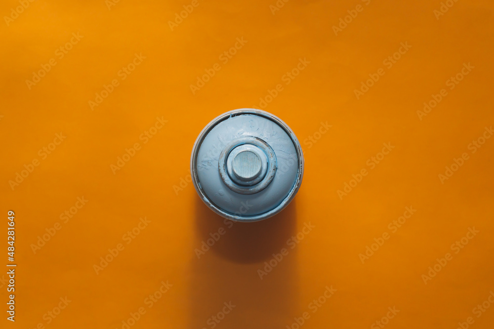 Can of spray paint on yellow background. view from above Can of spray paint on yellow background. view from above