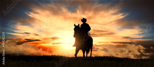Cowboy on a horse at sunset