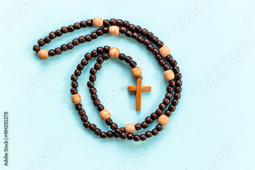 Fotografie, Obraz Wooden rosary beads with cross, top view. Christian concept
