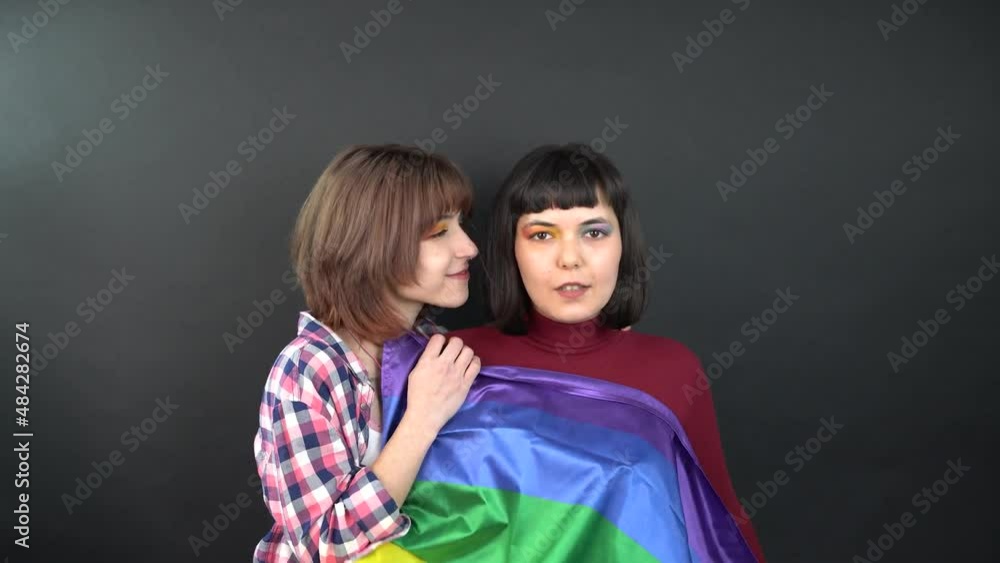 Lesbian couple, happy girl homosexual dancing and having Fun with flag symbolic expression LGBTQ flag. Lesbian couple, happy girl homosexual dancing and having Fun with flag symbolic expression LGBTQ flag.