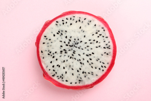 Delicious cut dragon fruit (pitahaya) on pink background, top view