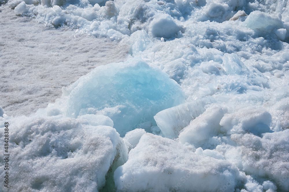 Melting river ice. Columnar and needle-like structure of crystals. Ice floe in the spring on the banks of the Amur River. Melting river ice. Columnar and needle-like structure of crystals. Ice floe in the spring on the banks of the Amur River.