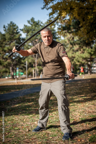 Instructor demonstrates katana sword fighting techniques and training methods © guruXOX