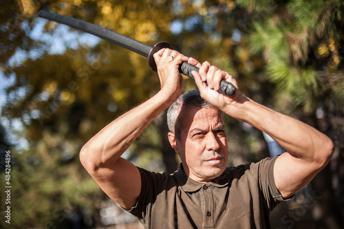 Instructor demonstrates katana sword fighting techniques and training methods