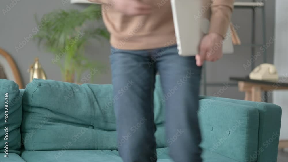 Man Closing Laptop, Leaving Sofa Man Closing Laptop, Leaving Sofa