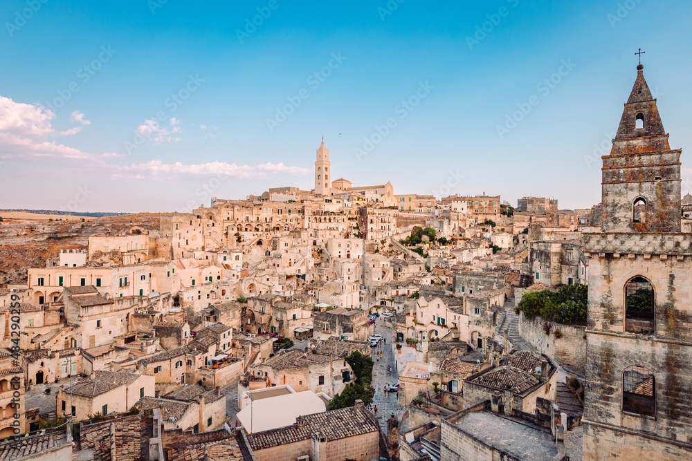 Wide view of the Sassi di Matera from the Belvedere di San Pietro Barisano, blue sky with clouds