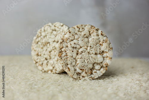 Tableau sur toile Standing rice buckwheat cake on a background of strewn rice groats