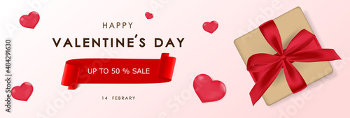Valentine day card with present and heart on pink background.