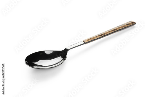 Stainless steel spoon with wooden handle on white background