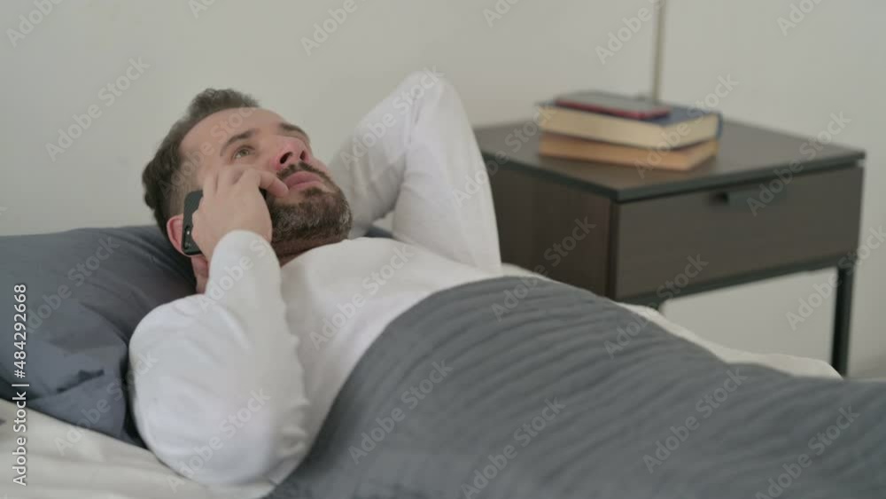 Man Talking on Call on Smartphone in Bed Man Talking on Call on Smartphone in Bed