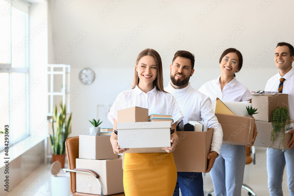 Business people holding boxes with things in office on moving day Business people holding boxes with things in office on moving day