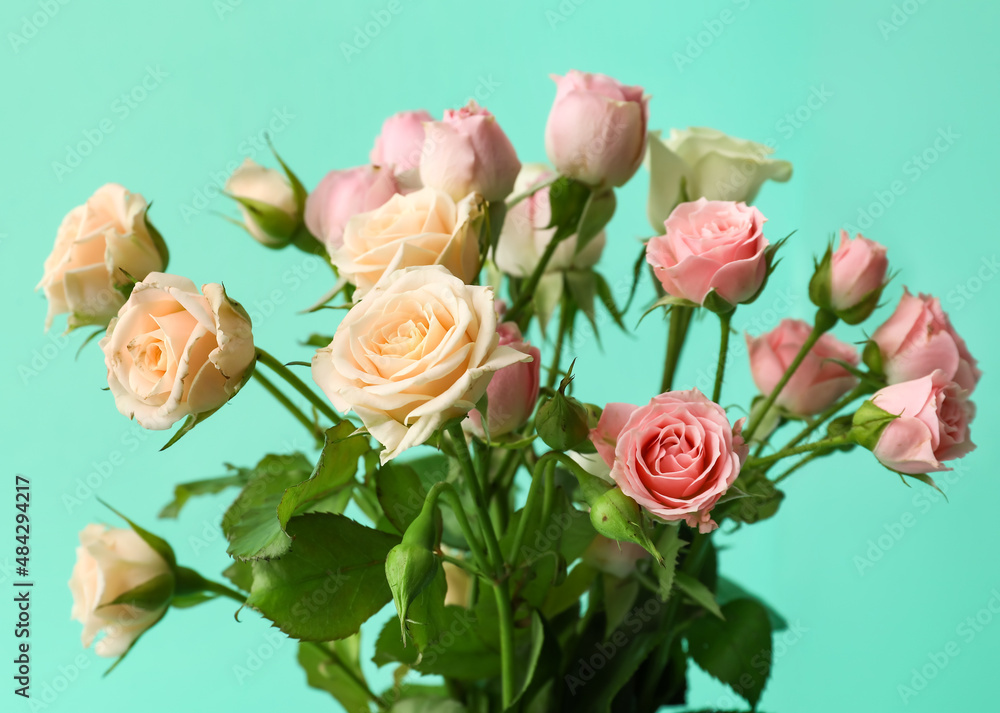 Bouquet of small roses on green background