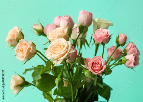 Bouquet of small roses on green background