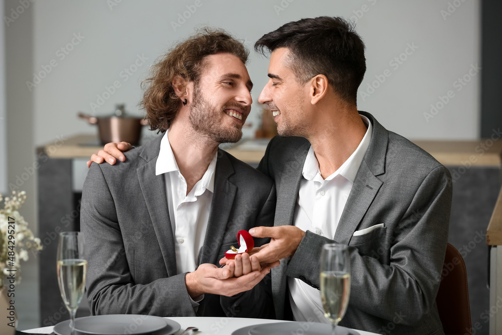 Young gay proposing to his boyfriend on romantic date Young gay proposing to his boyfriend on romantic date