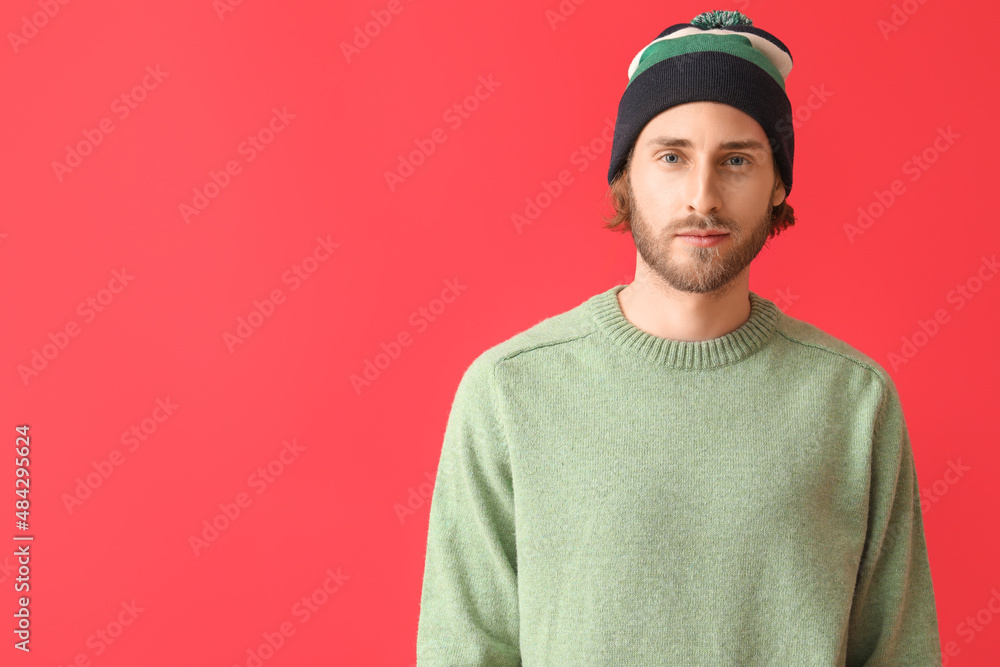 Handsome young man in knitted sweater on color background Handsome young man in knitted sweater on color background