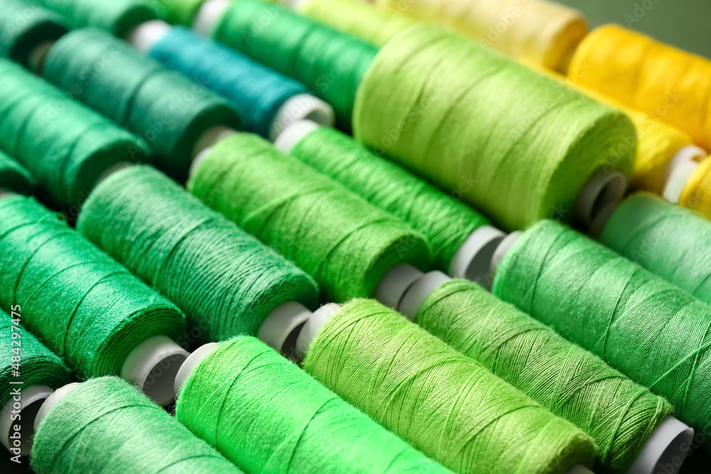 Spools with green threads, closeup Spools with green threads, closeup