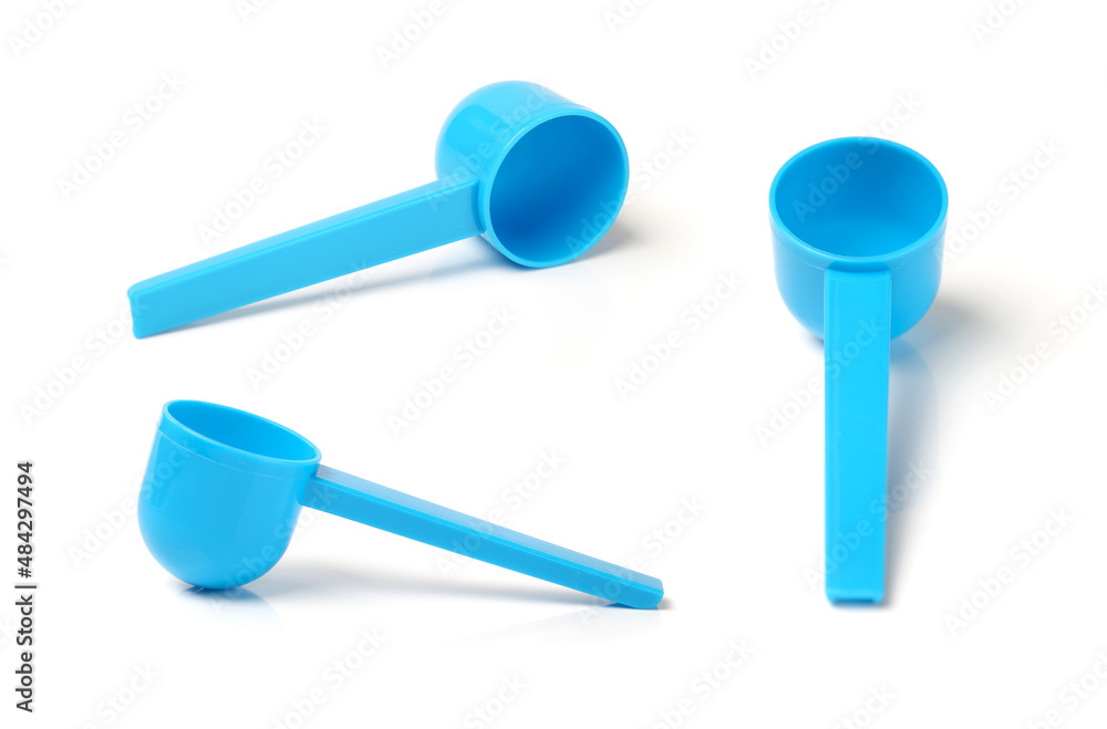 Blue plastic measuring spoon on white background Blue plastic measuring spoon on white background