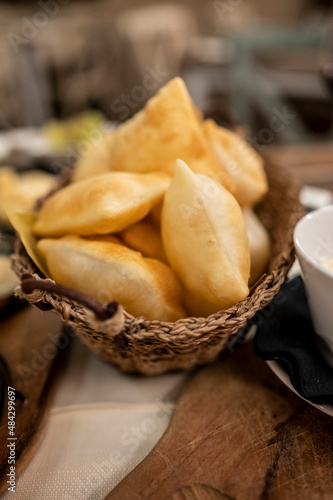 Food of Emilia Romagna region, deep fried bread gnocco fritto or crescentina served in restaurant in Parma, Italy